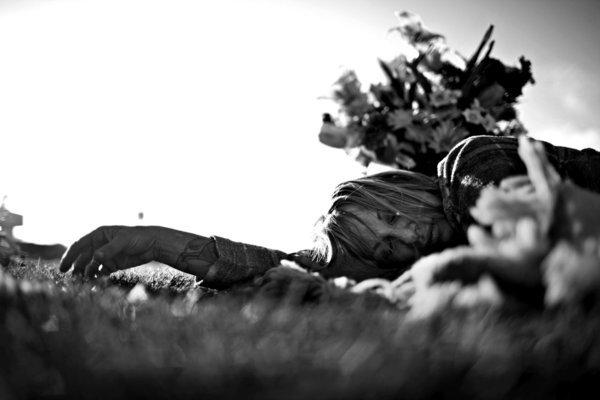 Leslie Greenberg lies in the grass at a park after leaving flowers at the nearby grave of her boyfriend Andrew Corless, who died in 2006 of prescription drug and alcohol intoxication. (Liz O. Baylen / Los Angeles Times)