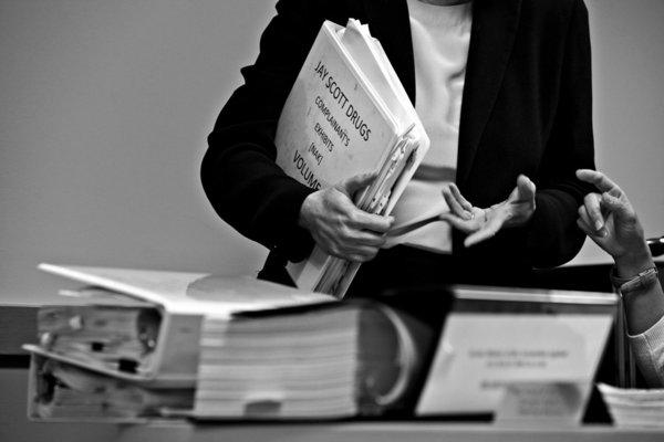 Binders of evidence fill the prosecutors' table at a hearing on Jay Scott Drugs (Liz O. Baylen / Los Angeles Times)