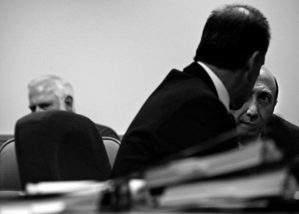 Albert Daher, right, talks with attorney Daniel R. Friedenthal at his hearing before the state Board of Pharmacy in November. Daher, owner of Jay Scott Drugs, denies any wrongdoing. (Liz O. Baylen / Los Angeles Times)