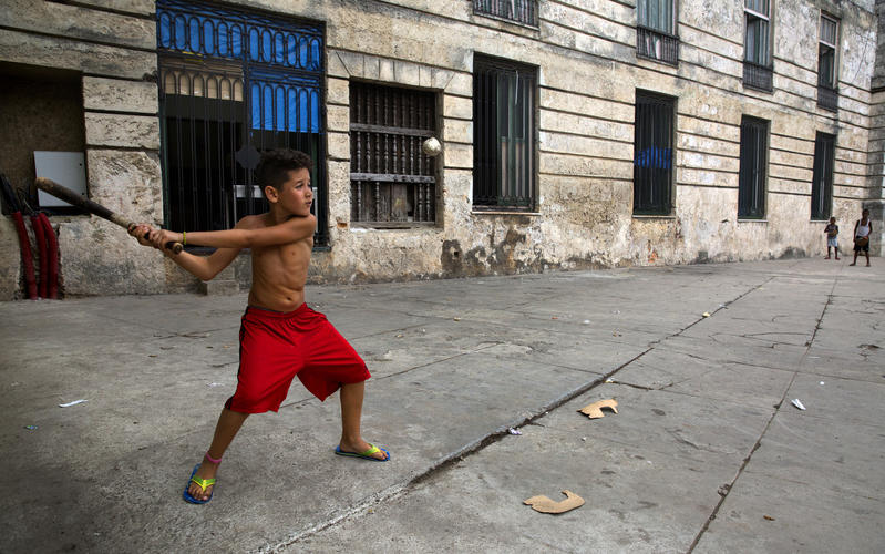 boy playing stickball